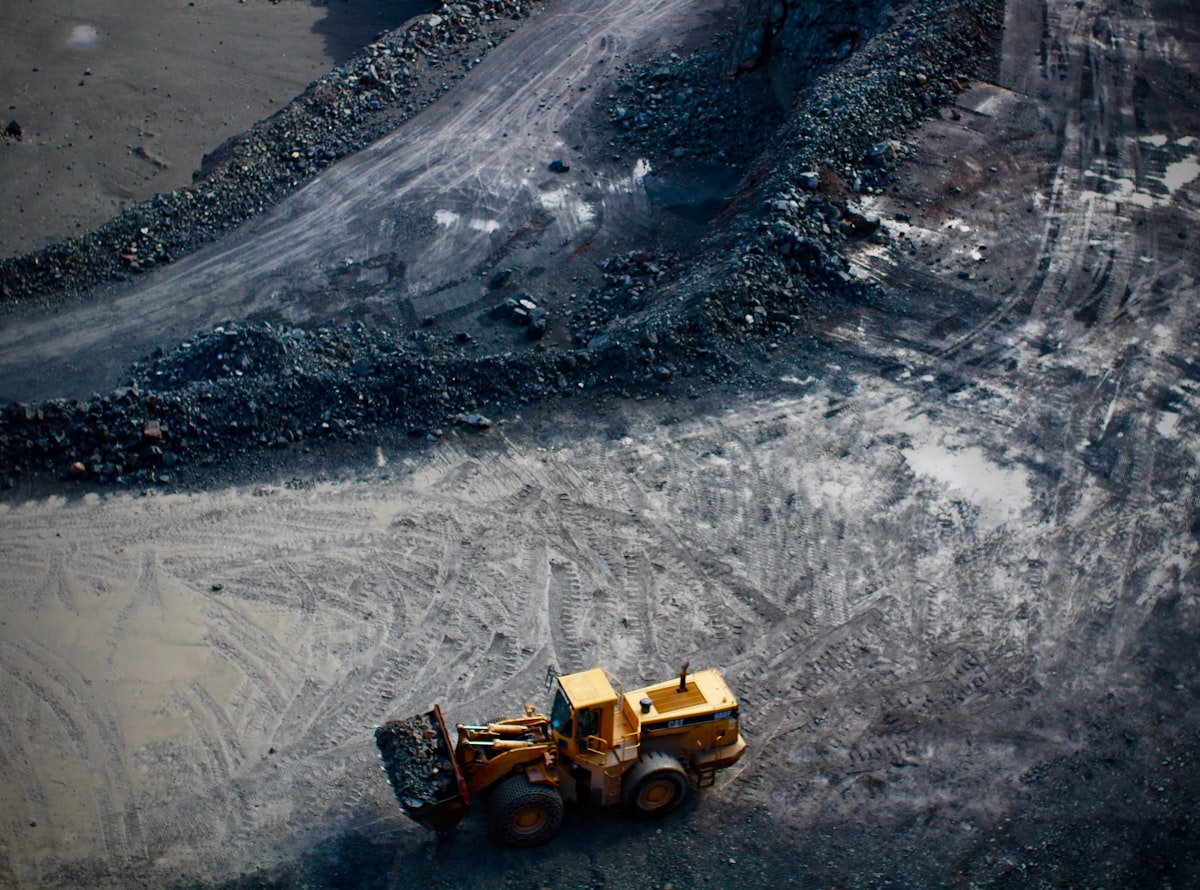 Excavator loading rock from a bench, seen from above